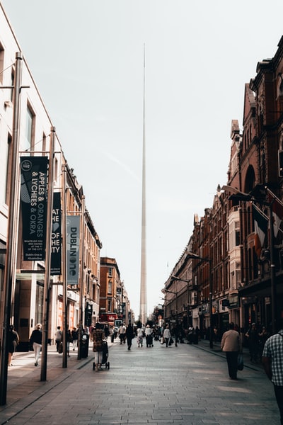 During the day, people walking in the streets of between buildings
